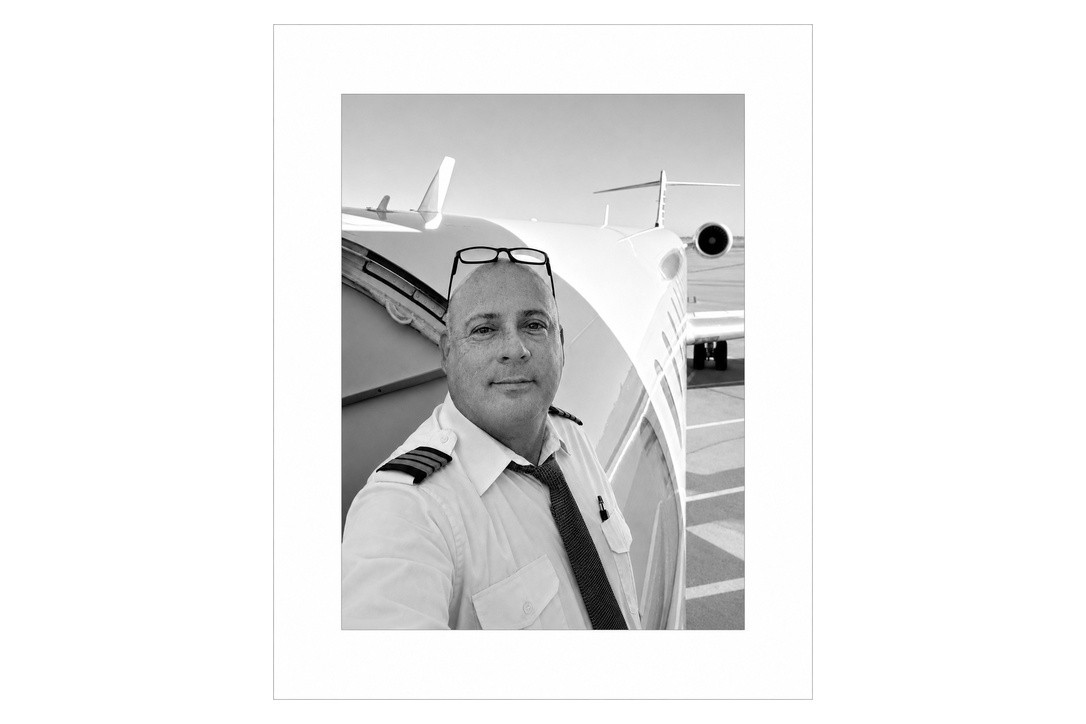 Steven De Lorie in pilot uniform beside an aircraft